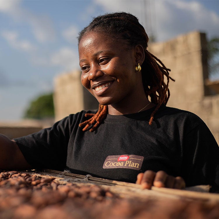 Woman drying the cocoa pods